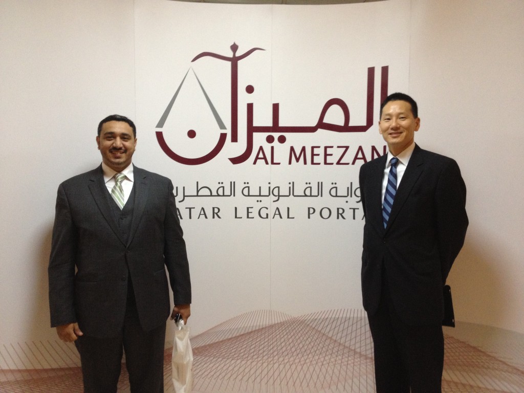George Sadek and David Mao stand in front of the banner for the new Qatar legal portal, Al Meezan.