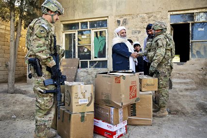 U.S. Army Lt. Col. Mark Martin, right, shakes hands with Mawlawi Guhlam M. Ruhaani, director of Hajj and Endowment, after delivering boxes of school supplies during a meeting with key leaders in Farah City, Afghanistan, Dec. 29, 2012. Martin is civil affairs team lead for Provincial Reconstruction Team Farah, which trains, advises and assists Afghan government leaders in Farah province. 