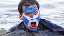 Image: A swimmer reacts during the New Year's Day Looney Dook swim at South Queensferry, Scotland, on Tuesday (© David Moir/Reuters)
