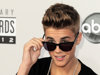 FILE - In this Nov. 18, 2012 file photo, Justin Bieber arrives at the 40th Anniversary American Music Awards in Los Angeles. Police say a paparazzo was hit by a car and killed after taking photos of Justin Bieber's white Ferrari on a Los Angeles street Tuesday evening Jan. 1, 2013. Los Angeles police Officer James Stoughton says the photographer, who was not identified, died at a hospital shortly after the crash Tuesday evening. Stoughton says Bieber was not in the Ferrari at the time. (Photo by Jordan Strauss/Invision/AP, File)
