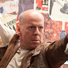 Joe (Bruce Willis) fights a younger version of himself in Looper.