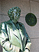 The First Lady, Eleanor Roosevelt standing before the United Nations emblem