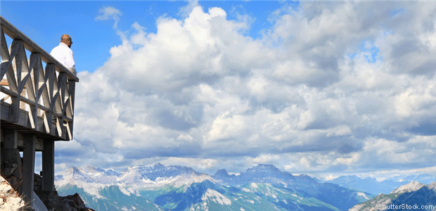 Man looking at clouds over the Rocky Mountains