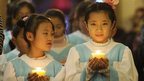 Young Chinese worshippers attend the Christmas Eve mass at a Catholic church in Beijing early on December 25
