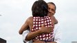 US President Barack Obama hugs First Lady Michelle Obama after she introduces him at  a campaign event in Davenport, Iowa 15 August 2012