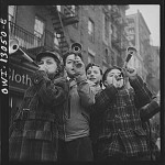 New York, New York. Blowing horns on Bleeker Street on New Year's Day (1943)