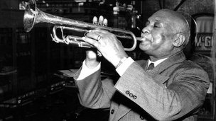 WC Handy playing a trumpet