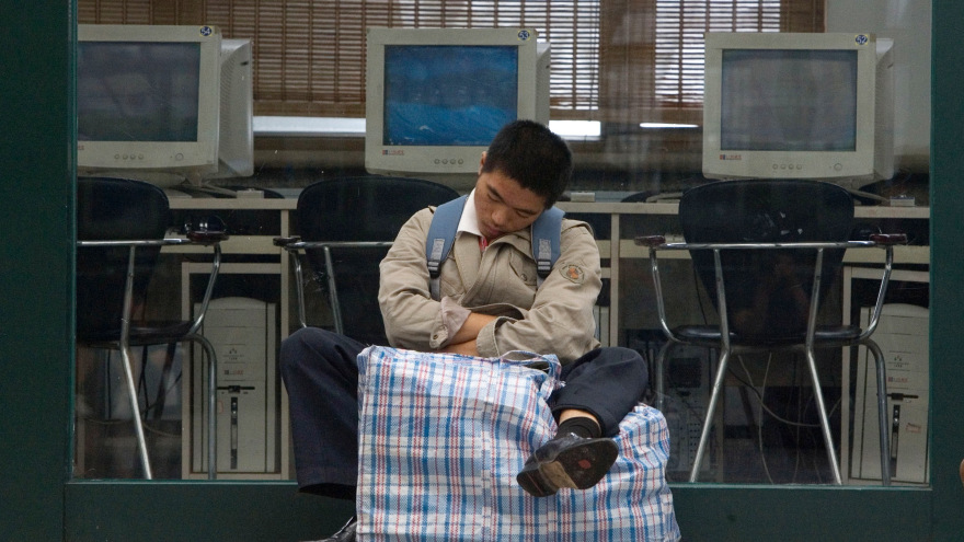 A Chinese man naps outside an internet cafe