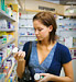 woman reading medicine bottle