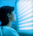 Woman sitting in front of UV lights