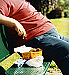 Overweight man sitting on park bench
