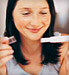 Woman smiling as she reads pregnancy test