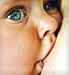 Close up on eyes of baby breastfeeding