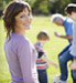 Woman watching family playing soccer