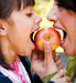 Mother and daughter sharing apple