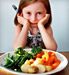 Unhappy girl with plate of vegetables