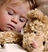 Child sleeping with bear