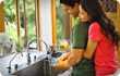 couple embracing by kitchen sink