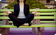 businesswoman on park bench meditating