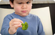 boy frowning at brocolli