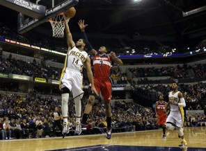 Indiana Pacers guard D.J. Augustin, left, shoots a layup in front of Washington Wizards guard Bradley Beal during the second half of an NBA basketball game on Wednesday, Jan. 2, 2013, in Indianapolis. The Pacers won 89-81. (AP Photo/AJ Mast)