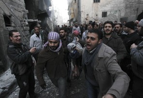 Men react as they carry a body of a person, whom activists said was killed by shelling by forces loyal to Syria's President Bashar al-Assad, at al-Ansari area in Aleppo January 3, 2013. REUTERS/Muzaffar Salman   (SYRIA - Tags: CONFLICT TPX IMAGES OF THE DAY)