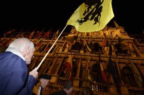 A New Flemish Alliance party supporter waves a Flemish flag at the townhall in Antwerp after local elections on October 14, 2012. Flemish nationalist leader Bart De Wever scored a breakthrough electoral win today and immediately called on Belgian Prime Minister Elio Di Rupo to radically re-shape the federal state. Hailing a 'historic' victory in Antwerp City Hall after his opponent conceded defeat before the results were all in, De Wever said Di Rupo and his federal coalition partners should 'assume your responsibility.'AFP PHOTO/BELGA /DIRK WAEM DIRK WAEM/AFP/GettyImages