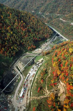 Aerial view of a valley with an industrial site in it.