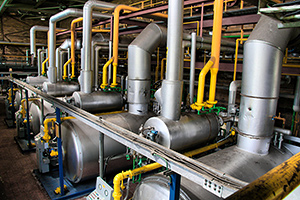 Boilers in large industrial space.