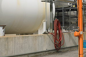 Outside storage tank with hose.