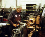 Dowling working at a lathe