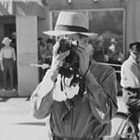 Tourist using candid camera, Taos, New Mexico, 1940.