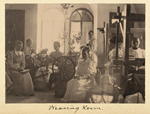 A group of women sitting near spinning wheels