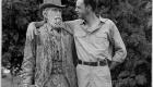 Wendell Berry with arm around statue