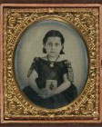 [Unidentified girl in mourning dress holding framed photograph of her father as a cavalryman with sword and Hardee hat]