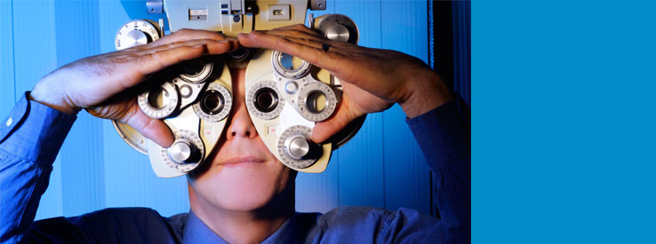 Man looking through ophthalmology machine