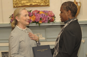 Acting Public Printer Davita Vance-Cooks presents Secretary of State Hillary Clinton a copy of Trafficking in Persons Report, which GPO produced for the State Department.