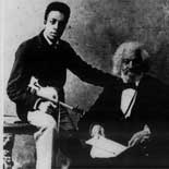 Frederick Douglass with his grandson Joseph H. Douglass, a concert violinist, ca. 1886.  Photograph.