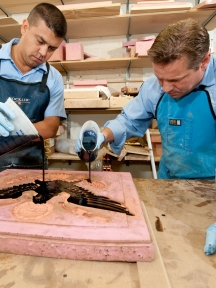 Employees of the AOC's House Carpentry Branch make a mold of an intricate seal