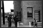 A railroad station with signs: 'Colored Waiting Room' and


     'Colored Men.'