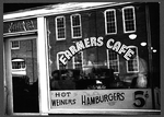 A cafe in the warehouse district during tobacco auction season with a separate door marked 'White.'