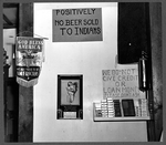 Signs behind the bar, including one that reads: 'Positively no beer sold to
Indians.'
