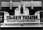 Sign above moving picture theater that reads 'The Gem Theatre


     Exclusive Colored Theatre.'