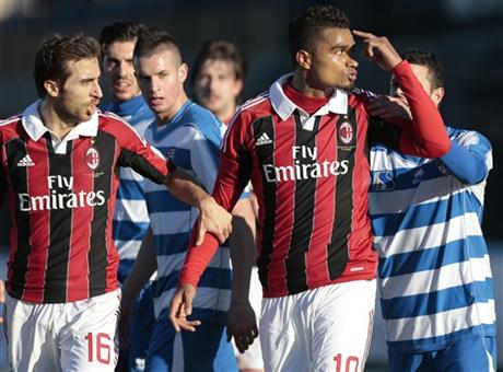 AC Milan Ghana midfielder Kevin-Prince Boateng, right, is flanked by his teammate Mathieu Flamini as he gestures towards the crowd in Busto Arsizio, near Milan, Italy, Thursday, Jan. 3, 2012.  (AP Photo/Emilio Andreoli)