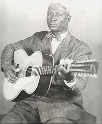 Huddie Ledbetter with his guitar