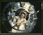 Woman working on part of the cowling for one of the motors for a B-25 bomber