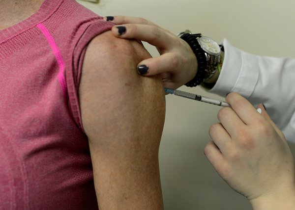 A woman gets a flu shot at a doctor's office in New York.