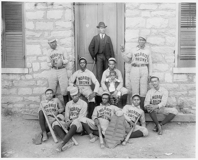 [African American baseball players from Morris Brown College, with boy and another man standing at door, Atlanta, Georgia] (LOC)