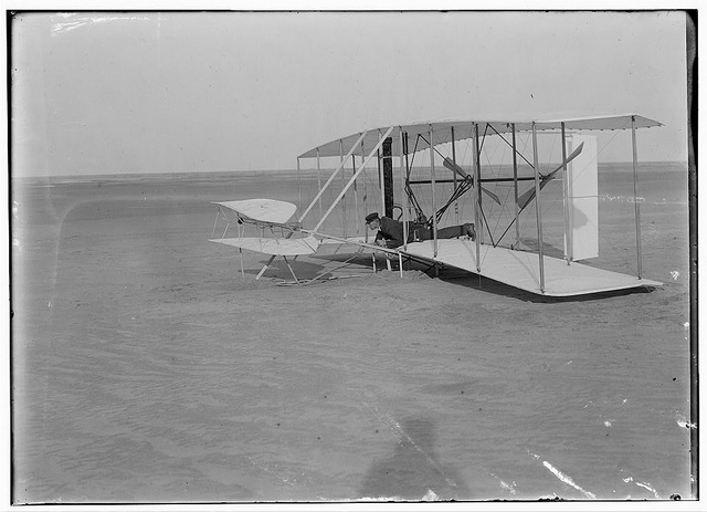 [Wilbur in prone position in damaged machine, on ground after unsuccessful trial of December 14, 1903, Kitty Hawk, North Carolina] (LOC)