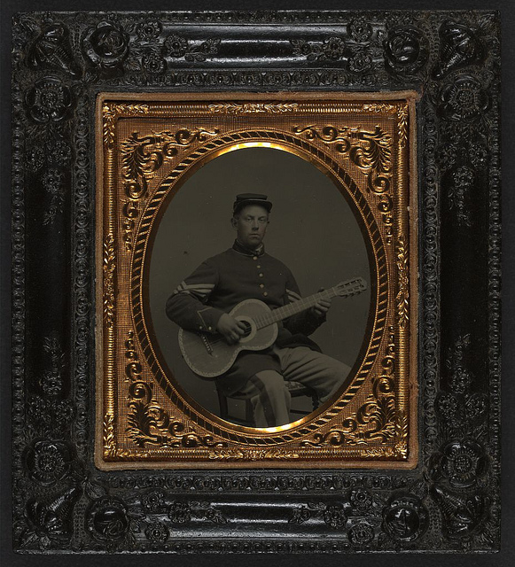 [Edwin Chamberlain of Company G, 11th New Hampshire Infantry Regiment in sergeant's uniform with guitar] (LOC)